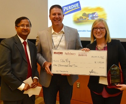 Pictured, from left:  Dr. Amit Poddar, MASMI director; and Geoff Turner, president and chief operating officer of Choptank Transport, presented a ceremonial check and award to inaugural sales competition winner Julia Rey.